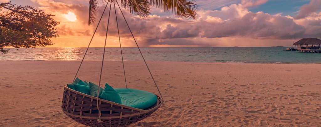 Ten Private Membership - Travel Inspiration For Summer And Autumn 2021 A swing chair overlooking the sea at sunset